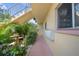 Outdoor patio area on the condo grounds, with seating and manicured hedges at 2003 Greenbriar Blvd # 1, Clearwater, FL 33763