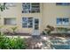 Charming condo exterior featuring a private entrance with surrounding shrubs and natural light at 2003 Greenbriar Blvd # 1, Clearwater, FL 33763