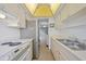 Galley kitchen with stainless steel refrigerator and views to the backyard at 2003 Greenbriar Blvd # 1, Clearwater, FL 33763