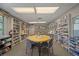 Community library with extensive bookshelves and a table for reading at 2003 Greenbriar Blvd # 1, Clearwater, FL 33763