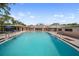 Community pool view with lounge chairs for relaxation and well-maintained landscaping at 2003 Greenbriar Blvd # 1, Clearwater, FL 33763