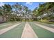 Outdoor shuffleboard courts surrounded by mature trees and landscaping at 2003 Greenbriar Blvd # 1, Clearwater, FL 33763