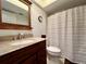 Charming bathroom featuring a granite vanity, a toilet, and a shower-tub combo at 2131 Ridge S Rd # 76, Largo, FL 33778