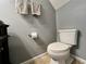 Bathroom featuring modern toilet and gray walls, complemented by neutral tiles at 2131 Ridge S Rd # 76, Largo, FL 33778