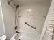 Clean bathroom featuring a toilet, and a shower-tub combo with grab bars at 2131 Ridge S Rd # 76, Largo, FL 33778