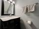 Bathroom with a marble countertop vanity, decorative mirror and modern fixtures at 2131 Ridge S Rd # 76, Largo, FL 33778