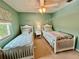 Cozy bedroom with twin beds, ceiling fan, and a bright window at 2131 Ridge S Rd # 76, Largo, FL 33778