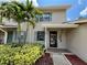 Charming home exterior featuring tropical landscaping, a covered front entry, and light blue shutters at 2131 Ridge S Rd # 76, Largo, FL 33778