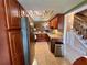 Long kitchen view showing the cabinets, appliances, and view of the adjacent stairway and living area at 2131 Ridge S Rd # 76, Largo, FL 33778
