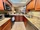 This kitchen has granite countertops, stainless appliances, and a view of the living area at 2131 Ridge S Rd # 76, Largo, FL 33778