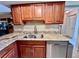 A well-lit kitchen featuring stainless steel appliances, granite countertops, and wood cabinetry at 2131 Ridge S Rd # 76, Largo, FL 33778