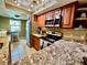 Well-lit kitchen featuring granite counters, stainless steel appliances and a breakfast nook with outdoor views at 2131 Ridge S Rd # 76, Largo, FL 33778