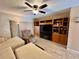 Living room with a entertainment center, comfortable recliner, and abundant natural light at 2131 Ridge S Rd # 76, Largo, FL 33778