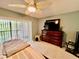 Comfortable main bedroom featuring a ceiling fan, large windows, and entertainment center at 2131 Ridge S Rd # 76, Largo, FL 33778