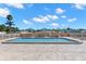Community pool with patio furniture and umbrellas for relaxation on a sunny day at 2131 Ridge S Rd # 76, Largo, FL 33778