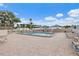 Spacious community pool area with lounge chairs and umbrellas for relaxing by the pool at 2131 Ridge S Rd # 76, Largo, FL 33778