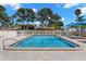 Community pool with clear blue water and paved patio for relaxation and recreation at 2131 Ridge S Rd # 76, Largo, FL 33778
