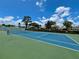 View of the blue and green community tennis court on a sunny day at 2131 Ridge S Rd # 76, Largo, FL 33778
