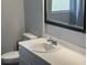 Clean bathroom with a vanity sink, toilet and a large mirror at 22365 Panorama St, Brooksville, FL 34601