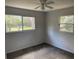 Cozy bedroom with neutral walls, carpet, and multiple windows for natural light at 22365 Panorama St, Brooksville, FL 34601