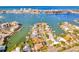 Aerial view of waterfront homes with docks and boats on the canal leading out to the ocean at 234 Palm Sw Is, Clearwater Beach, FL 33767