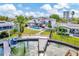 Breathtaking aerial view of a waterfront home with a pool, dock, lush landscaping, and canal access at 234 Palm Sw Is, Clearwater Beach, FL 33767