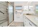 Updated bathroom featuring a glass-enclosed shower and granite countertops at 234 Palm Sw Is, Clearwater Beach, FL 33767