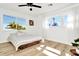 Bright bedroom features a platform bed, wood floors, and large windows that let in ample sunlight at 234 Palm Sw Is, Clearwater Beach, FL 33767