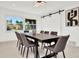Elegant dining room with modern lighting, a large table, and a stylish sliding barn door at 234 Palm Sw Is, Clearwater Beach, FL 33767