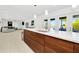 Open-concept kitchen featuring a large island, modern wood cabinets, and views of the living space at 234 Palm Sw Is, Clearwater Beach, FL 33767
