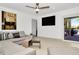 Relax in this living room with a comfy sectional and a door to access the outdoor deck at 234 Palm Sw Is, Clearwater Beach, FL 33767