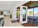 Indoor-outdoor living space with folding glass doors, connecting the kitchen to an outdoor dining area at 234 Palm Sw Is, Clearwater Beach, FL 33767