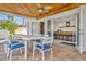 Covered patio with dining table, ceiling fan, and direct access to the modern kitchen and outdoor area at 234 Palm Sw Is, Clearwater Beach, FL 33767
