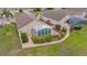Aerial view of a home with enclosed porch, mature landscaping and brick walkways at 241 Royal Palm Way, Spring Hill, FL 34608