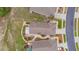 Aerial view shows the roof and landscaped backyard, plus screened patio, of a well-maintained single-Gathering home at 241 Royal Palm Way, Spring Hill, FL 34608