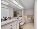 Bright bathroom featuring double sinks, a large mirror, and a luxurious soaking tub at 241 Royal Palm Way, Spring Hill, FL 34608