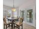 Bright breakfast nook with table, chairs, and natural light from windows and glass doors at 241 Royal Palm Way, Spring Hill, FL 34608