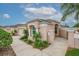 Single-story home featuring a two-car garage, manicured lawn, and tasteful landscaping at 241 Royal Palm Way, Spring Hill, FL 34608