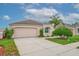 Charming single-story home featuring a two-car garage and manicured landscaping in a suburban neighborhood at 241 Royal Palm Way, Spring Hill, FL 34608