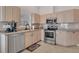 Kitchen featuring stainless steel appliances, light wood cabinets, and tile flooring at 241 Royal Palm Way, Spring Hill, FL 34608