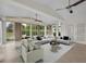 Living room with neutral decor, multiple ceiling fans, and lots of windows for natural light at 241 Royal Palm Way, Spring Hill, FL 34608