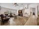 Spacious living room with hardwood flooring, ceiling fan, and lots of natural light at 241 Royal Palm Way, Spring Hill, FL 34608