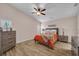 Main bedroom with wood floors, a ceiling fan, matching dressers and a comfortable bed at 241 Royal Palm Way, Spring Hill, FL 34608