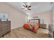 Main bedroom with wood floors, a ceiling fan, matching dressers and a comfortable bed at 241 Royal Palm Way, Spring Hill, FL 34608