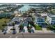 Aerial view of waterfront homes featuring lush landscaping, private docks, and beautiful water views at 2801 Gulf Blvd, Belleair Beach, FL 33786