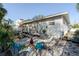 Spacious backyard with a wooden deck, patio seating, and lush landscaping perfect for outdoor enjoyment at 2801 Gulf Blvd, Belleair Beach, FL 33786