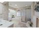Relaxing bathroom with tub, shower, double sinks, and lots of natural light in a pleasant setting at 2801 Gulf Blvd, Belleair Beach, FL 33786