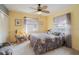 Cozy bedroom with yellow walls, carpet flooring, ceiling fan and windows allowing natural light to enter at 2801 Gulf Blvd, Belleair Beach, FL 33786
