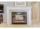 Elegant fireplace with white mantel, marble hearth and black trim in an elegantly designed living room at 2801 Gulf Blvd, Belleair Beach, FL 33786