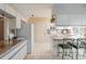 Well-lit kitchen featuring ample counter space, white cabinets, and island with seating at 2801 Gulf Blvd, Belleair Beach, FL 33786